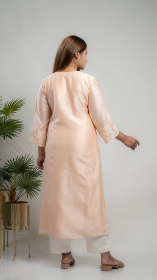 Powder pink Chanderi silk kurta with pearls and sequins.