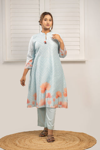 Powder blue Chanderi silk kurta with floral print and tassels.